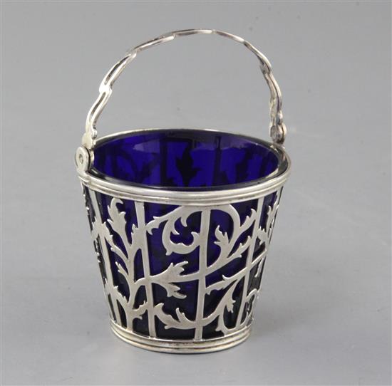 A George III pierced silver sugar basket with blue glass liner, 6cm.